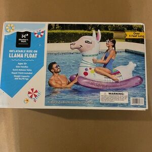 Members Mark giant ride on Llama pool float.